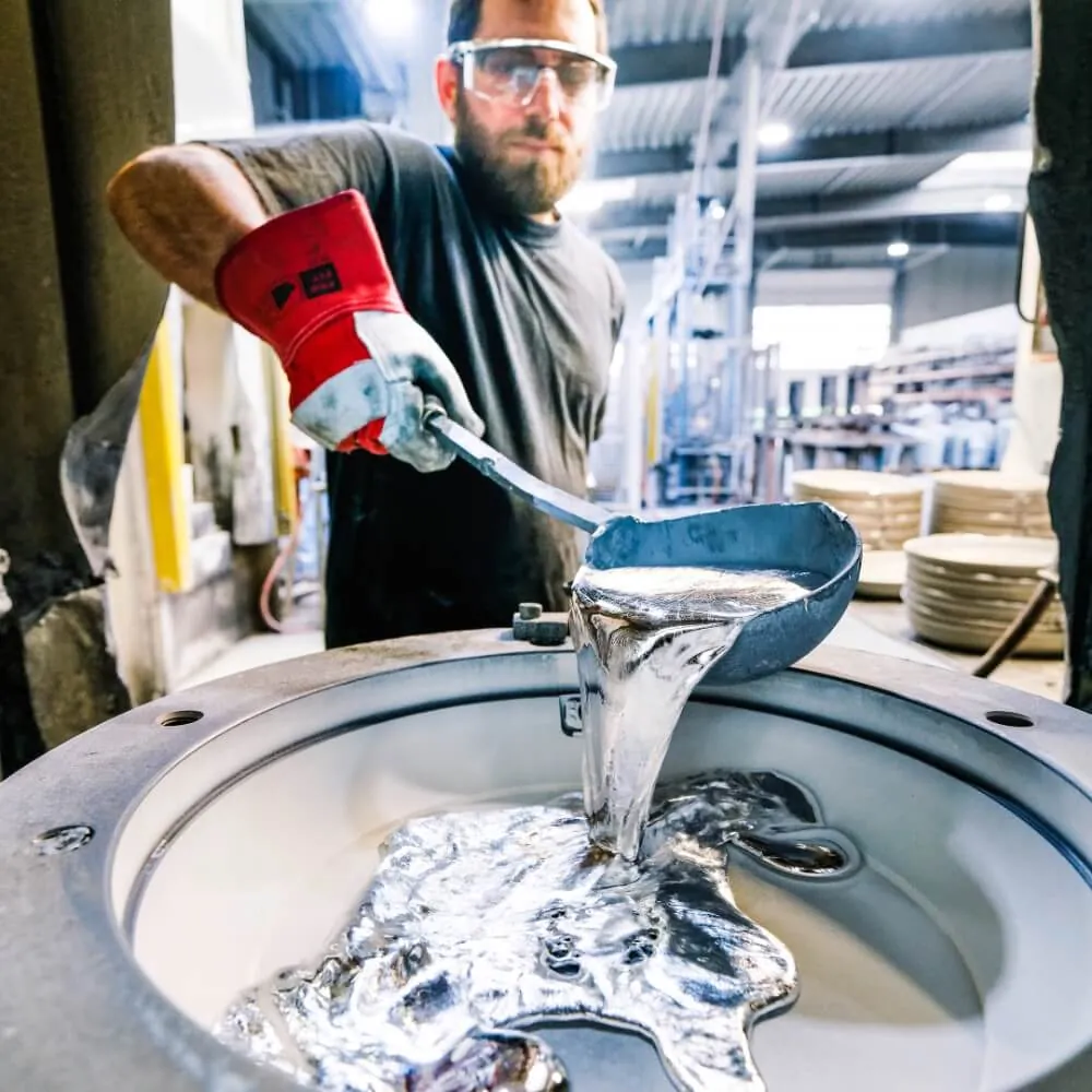 Molten aluminium alloy poured by hand into a mould