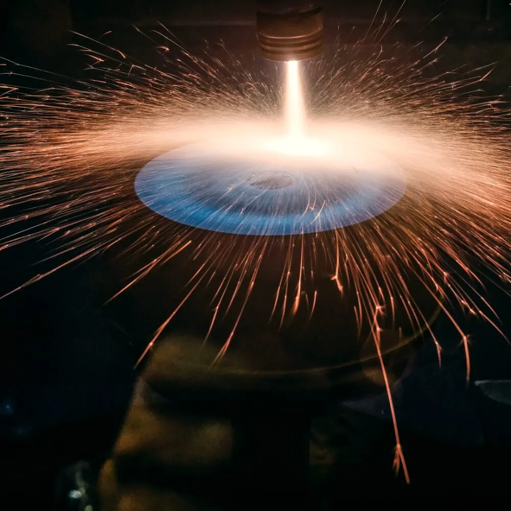 Sparks as the titanium surface is applied to a pan body